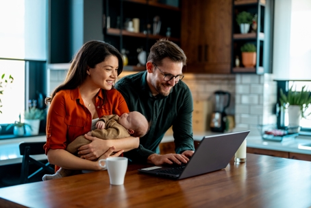 a young family in front of a laptop